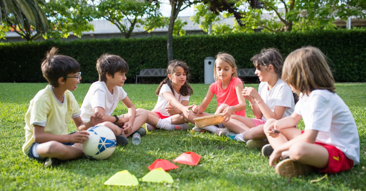 A group of kids enjoying outdoor games on a sunny day in a park in Portugal, fostering friendship and fun.